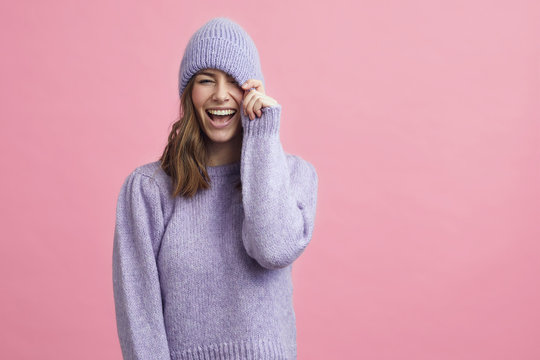 portrait of young woman in a nice winter sweater that matches the background 