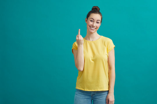 Flippant young woman is crossing her finger and hoping that its going her way