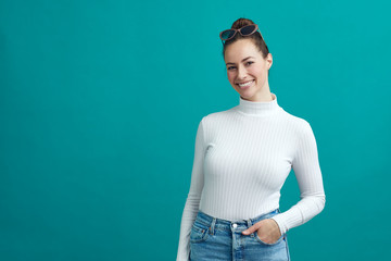 Happy girl smiling while standing on a nice colorful background