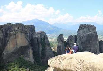 couple hikers looking at mountains in Meteora, Greece