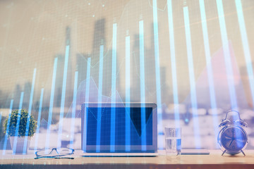 Forex graph hologram on table with computer background. Multi exposure. Concept of financial markets.