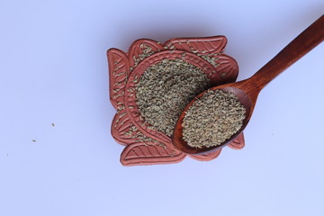 Ajwain seeds in bowl and wooden spoon