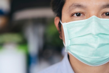 Closeup man wearing hygienic mask to prevent infection.