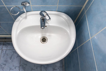 sink with faucet in bathroom with blue tile on walls