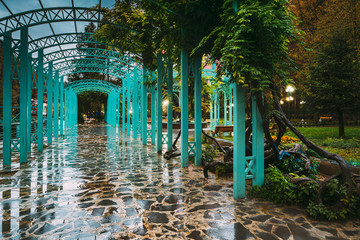 Borjomi, Samtskhe-Javakheti, Georgia. Arch Entrance To Pavilion Above Hot Spring Of Borjomi Mineral Water. Famous Local Landmark Is City Park At Autumn October Night.