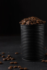 Roasted coffee beans in a black tin can, whole coffee beans in black can