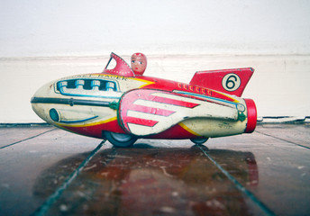retro rocket toy with girl pilot