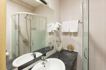 Interior of a hotel bathroom with glass shower cabin