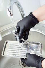 Dental instrument disinfection. Rinse a medical instrument under running water. Disinfection in a medical center, hospital, office. Patient Care The best care for a medical instrument.