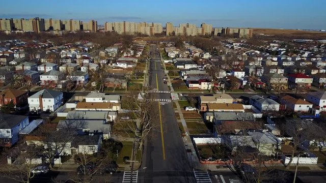 Aerial Descend Shot with Camera Tilt Down of Urban Neighborhood