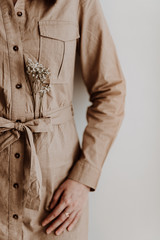 Woman in a beige dress with flower