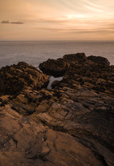 sunset on coast of sea