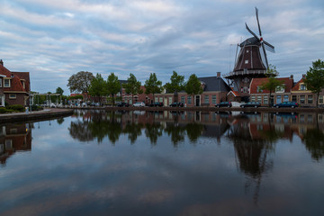 Fototapeta premium Water canal in Meppel, Holland at sunrise. The background is the sky with clouds.