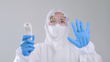 Asian Medical worker scanning with infrared thermometer, IR Thermo scan, Confident Asian doctor in...