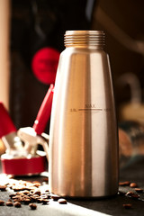 Creamer for home nitro coffee. Coffea beans around, sun atmosphere. Equipment