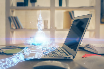 Desktop computer background in office and start up theme hologram drawing. Double exposure. Startup...