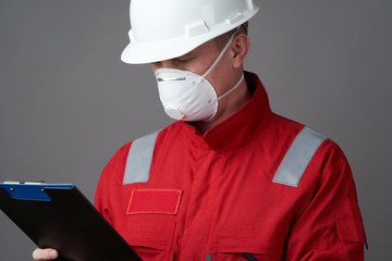 Man engineer, construction worker wearing face mask