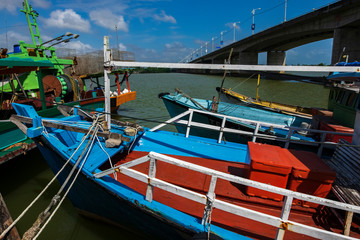 Traditional fishing boat moored at village located in Terengganu, Malaysia under blue sky background