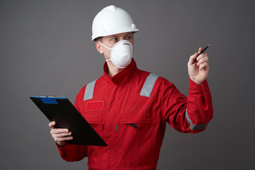 Man engineer, construction worker wearing face mask