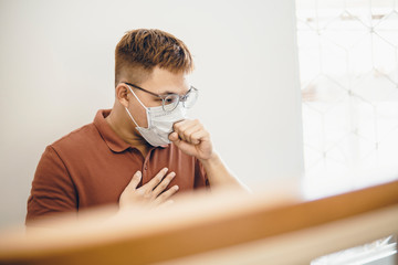 Asian man sick and cough when wearing medical mask