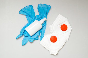 Hygiene products during Coronavirus Pandemic COVID-19. Medical masks and respirators with a red...