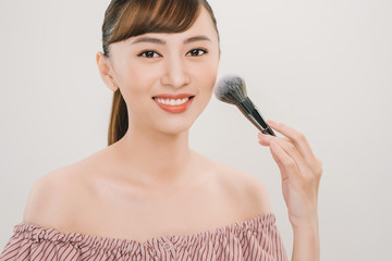 Young asian woman  makeup brush. Make up and beauty treatment concept shoot