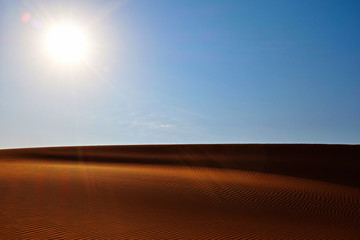 Bright sun, clear sky and desert sand dunes of Riyadh, Saudi Arabia