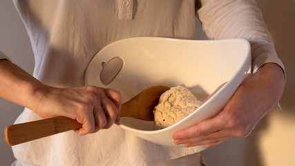 Close-up of hands kneading bread dough
