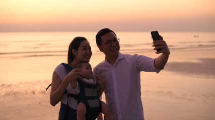 Holiday concept. Parents and children are taking pictures together at the seaside. 4k Resolution.