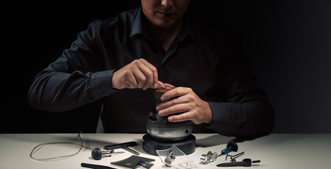 Engraver jeweller at work. Hands close up. Professional tools for jewelleries craftmanship....