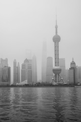 Shanghai, China, the river and the skyscrapers in a foggy morning