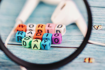 magnified image of colorful World Radio Day word cube on wooden background