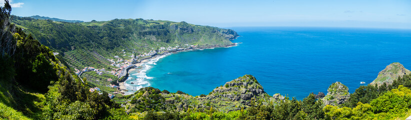 Fototapeta na wymiar Panorama on the Azores Island Santa Maria - Bay with a small village, coast line and the blue ocean on a sunny 