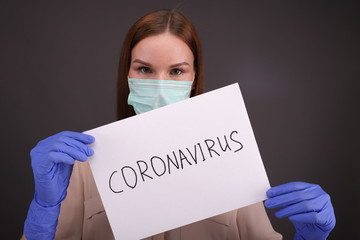 Female doctor holds a sign to stop coronavirus