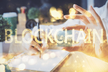 Cryptocurrency hologram over hands taking notes background. Concept of blockchain. Multi exposure
