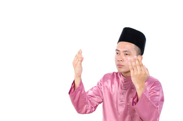Portrait of young and handsome asian man with traditional praying over white background - 333665627
