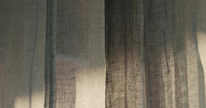 Slow motion closeup of linen transparent curtains moved by a wind