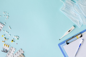 medical concept on a blue background. stethoscope, pills, tablet, notepad, sheet of paper, pen....