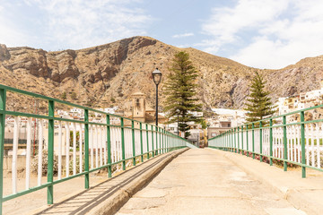 Fototapeta na wymiar pedestrian bridge over Nacimiento river in Alboloduy town, province of Almeria, Andalusia, Spain