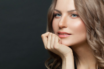 Fototapeta premium Beautiful woman face on black, close up female portrait