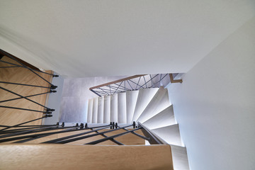 Stairs to the top. Design stairs made of metal and wood. backed up. Metal railing in black