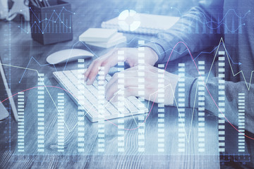 Multi exposure of financial graph with man works in office on background. Concept of analysis.