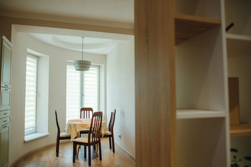 Eating area in studio apartment. Cupboard on the foreground.