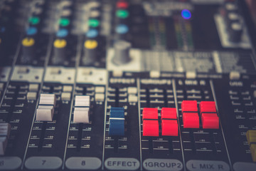 Detail with adjusting knobs on a professional audio mixer