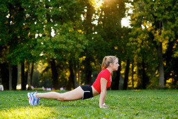 Young girl doing yoga in nature in the park