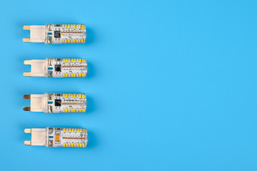 Several LED bulb on blue background. Saving energy concept. Ftat lay, top view, copy space. Bulbs...