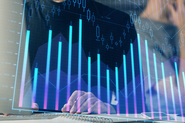 Forex graph with businessman typing on computer in office on background. Concept of analysis....