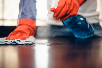 Cropped shot of an asian man cleaning a kitchen table at home