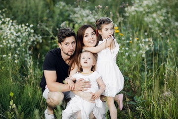 Obraz premium Happy young family spending time together outside in green nature