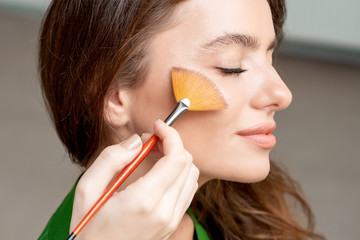 Makeup artist using brush.